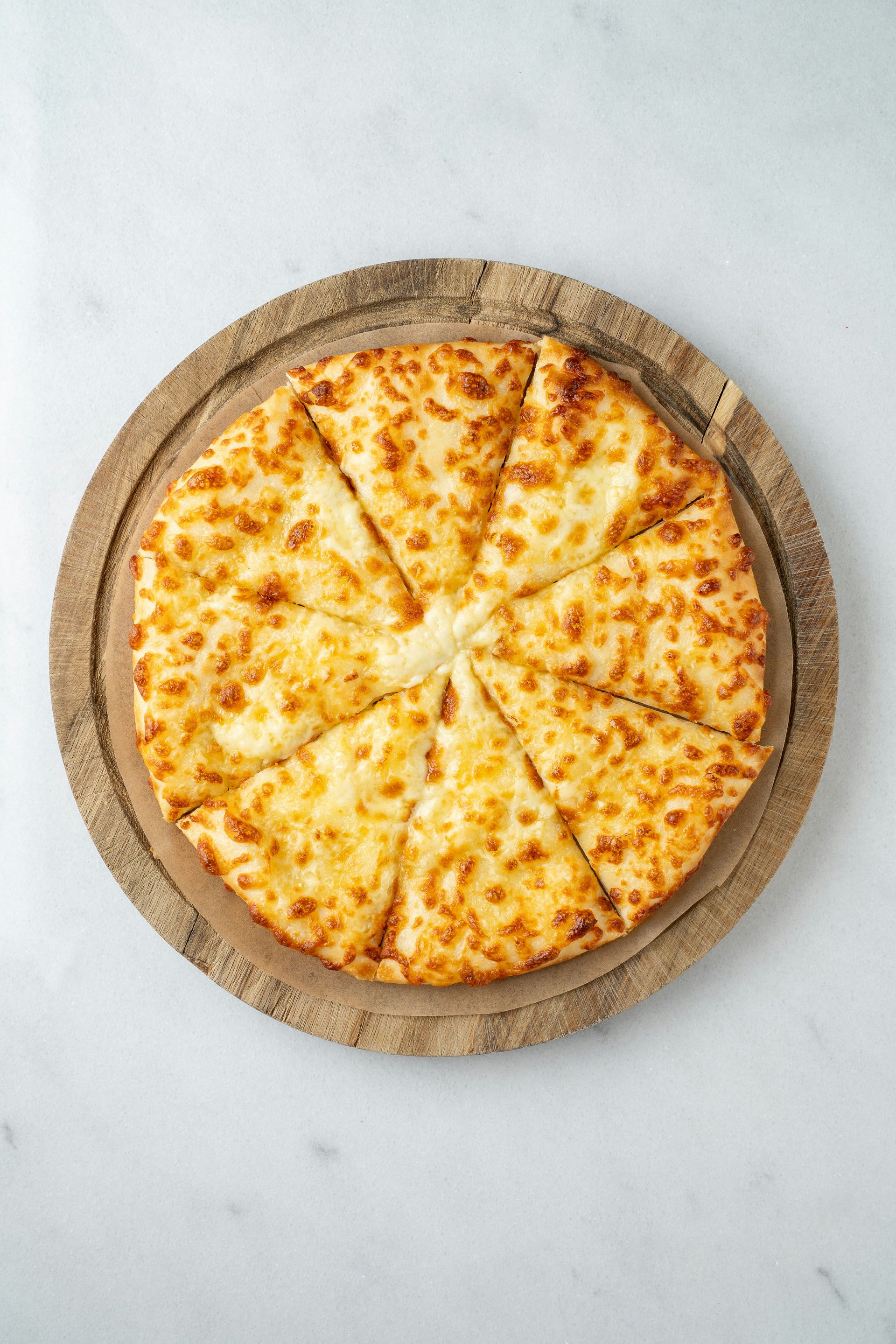 A pizza sitting on top of a wooden cutting board